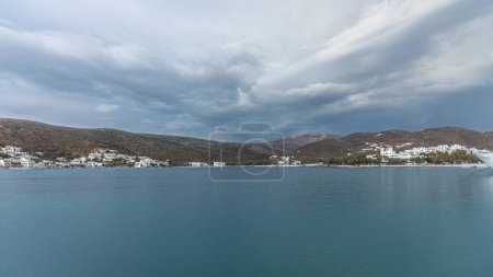 Foto de Panorama showing Amorgos island timelapse at evening during sunset. Traditional Greece - white houses on hills and ship in sea port in harbor, Cyclades - Imagen libre de derechos