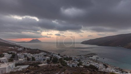 Photo for Panorama showing sunset on Amorgos island aerial timelapse from above. Traditional Greece - white houses on hills and turquoise sea, Cyclades - Royalty Free Image