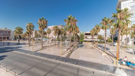 Photo for Panorama showing aerial view of the fountains and palms on the main square (Sheshi Liria) in Durres timelapse, Albania with the city hall and theater. Traffic on the street and people walking around - Royalty Free Image