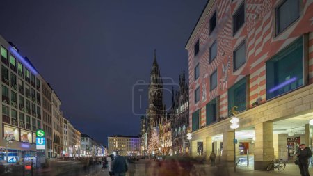 Photo for Marienplazt Old Town Square with New Town Hall night timelapse hyperlapse. Neues Rathaus and Town Hall Clock Tower Glockenspiel. Munich skyline, downtown cityscape. Rainy weather. Bavaria, Germany - Royalty Free Image
