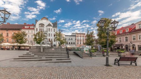 Photo for Panorama showing Neptune fountain on Old Town Market Square timelapse with historical houses around. Many cafes with umbrellas. Old town in Bielsko-Biala city, Poland - Royalty Free Image