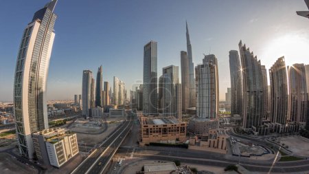 Photo for Aerial panorama of Dubai Downtown skyline with many towers night to day transition timelapse. Business area in smart urban city. Skyscrapers and high-rise buildings from above before sunrise, UAE. - Royalty Free Image