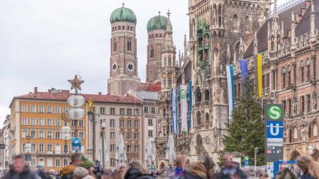 Photo for Marienplazt Old Town Square with the New Town Hall timelapse. Neues Rathaus and Town Hall Clock Tower Glockenspiel. Munich skyline, downtown cityscape near exit from the metro. Bavaria, Germany - Royalty Free Image