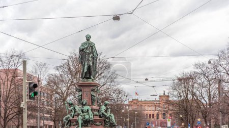 Maxmonument, Monument of Maximilian II of Bavaria timelapse, Maximilianstrasse street, Munich, Bavaria, Germany, Europe. Traffic on the road with tram rails. Maximilianeum building on a background