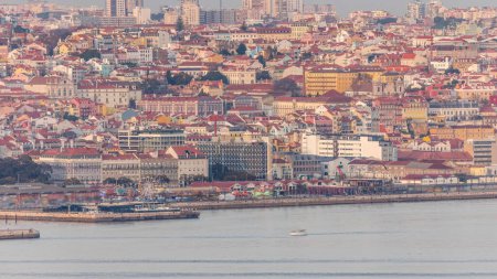 Photo for Aerial view of Lisbon skyline around Santos district, docks and the Tagus River timelapse taken from The Cristo Rei Sanctuary in Almada on the Southern margin during sunset. Lisbon, Portugal. - Royalty Free Image