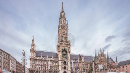 Marienplazt Old Town Square with the New Town Hall timelapse hyperlapse. Neues Rathaus and Town Hall Clock Tower Glockenspiel. Munich skyline, downtown cityscape with cloudy sky. Bavaria, Germany