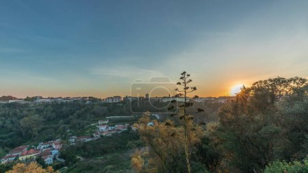Photo for Panorama showing sunset over the Castle of Almourol on hill in Santarem aerial timelapse. A medieval castle atop the islet of Almourol in the middle of the Tagus River and houses. Portugal - Royalty Free Image