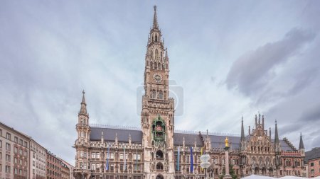 Photo for Marienplazt Old Town Square with the New Town Hall timelapse hyperlapse. Neues Rathaus and Town Hall Clock Tower Glockenspiel. Munich skyline, downtown cityscape with cloudy sky. Bavaria, Germany - Royalty Free Image
