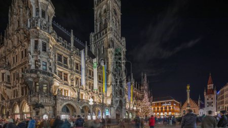 Photo for Marienplazt Old Town Square with Town Hall Clock Tower Glockenspiel night timelapse hyperlapse. Neues Rathaus or New Town Hall. Munich skyline, downtown cityscape. Bavaria, Germany - Royalty Free Image