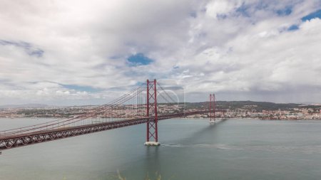 Photo for Panorama showing Lisbon cityscape with landmark suspension 25 of April bridge and Tagus river timelapse, aerial view of Old Town Alfama from viewpoint of Cristo Rei in Almada. Portugal - Royalty Free Image