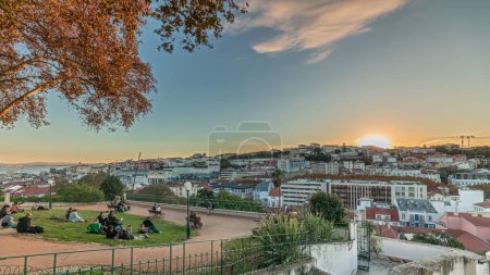 Photo for Panorama showing Jardim do Torel timelapse, a traditional garden and viewpoint with unusual views to the city center of Lisbon during sunset. It has a terrace, a bar and a large pond. Portugal - Royalty Free Image