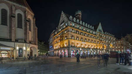 Photo for Kaufingerstrasse, shopping street and pedestrian zone in Munich downtown near the Marienplatz night timelapse. Panorama of historic buildings with people walking around. Bavaria, Germany - Royalty Free Image