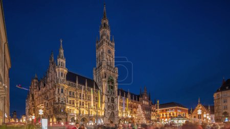 Photo for Marienplazt Old Town Square with New Town Hall day to night transition timelapse hyperlapse. Neues Rathaus and Town Hall Clock Tower Glockenspiel. Munich skyline, downtown cityscape. Bavaria, Germany - Royalty Free Image