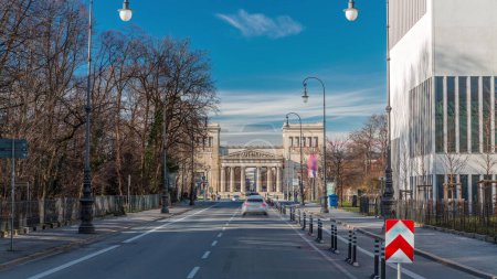 Photo for Propylaea or Propylaen timelapse with traffic on Brienner street. Monumental city gate in Konigsplatz (King's Square), Munich, Germany, Europe. The building in Doric order, entrance for Acropolis - Royalty Free Image