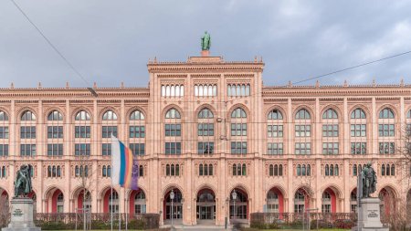 Photo for Building of the district government of Upper Bavaria (Regierung von Oberbayern) timelapse. Front view with monuments and flags. Traffic on the road. Munich, Germany - Royalty Free Image