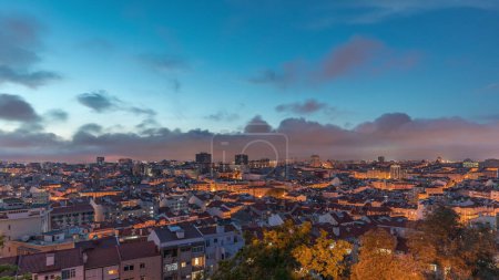 Photo for Panorama showing aerial view of downtown of Lisbon day to night transition timelapse, Portugal. Red roofs of typical houses in old town skyline. Historical district after sunset in capital city - Royalty Free Image
