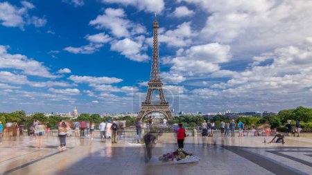 Photo for Trocadero square with Eiffel tower in the background timelapse hyperlapse. Trocadero and Eiffel tower are the most visited attractions of Paris. Blue cloudy sky at summer day - Royalty Free Image