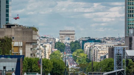Photo for Elevated view from Defense business district to the Arc de Triumph timelapse. Skyscrapers and traffic with many cars on road. Cloudy sky at summer day. Paris, France - Royalty Free Image