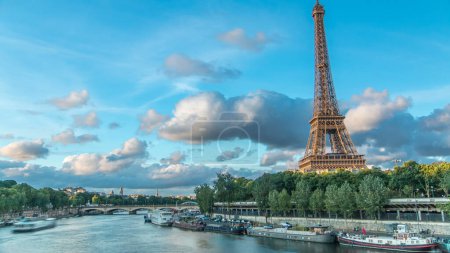 Photo for Eiffel Tower with boats at evening timelapse Paris, France. Aerial view from Bir-Hakeim bridge before sunset. Blue cloudy sky at summer day - Royalty Free Image