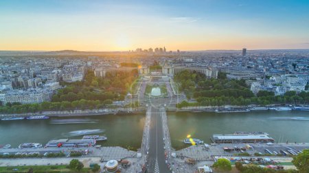 Photo for Sunset over Trocadero timelapse with the Palais de Chaillot seen from the Eiffel Tower viewpoint in Paris, France. Top view from observation deck with river Seine and ship crossing it at summer day - Royalty Free Image