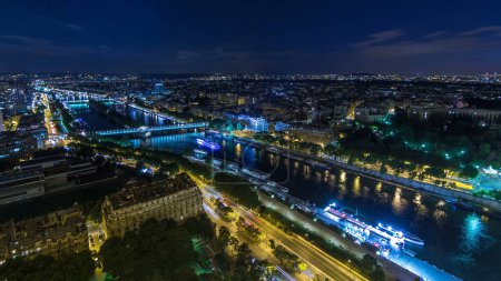 Photo for Aerial night timelapse view of Paris City and bridges over Seine river shot on the top of Eiffel Tower observation deck. Evening illumination. - Royalty Free Image