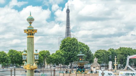 Photo for Fountains de la Concorde on Place de la Concorde timelapse in Paris, France. Traffic on road and Eiffel tower on background. Blue cloudy sky and green trees at summer day - Royalty Free Image