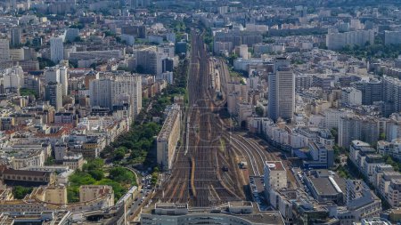 Photo for Top view of Paris skyline with train station of Vaugirard-Belt from above timelapse. Main landmarks of european megapolis. Bird-eye view from observation deck of Montparnasse tower. Paris, France - Royalty Free Image