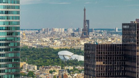 Photo for Paris skyline overview and Eiffel Tower timelapse from the top of the skyscrapers in Paris business district La Defense. Sunny summer day. Paris, France - Royalty Free Image