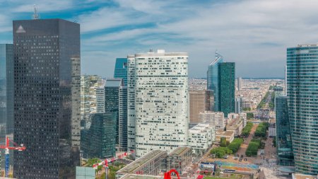 Photo for Aerial overview of Paris and modern towers timelapse from the top of the skyscrapers in Paris business district La Defense. Sunny summer day with blue cloudy sky. Paris, France - Royalty Free Image