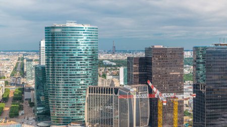 Photo for Paris skyline and skyscrapers with Eiffel Tower and park timelapse from the top of the towers in Paris business district La Defense. Sunny summer day. Paris, France - Royalty Free Image