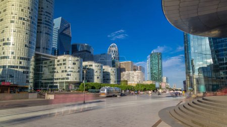 Photo for Skyscrapers of La Defense timelapse hyperlapse - Modern business and residential area in the near suburbs of Paris, France. Blue sky at sunny summer day. - Royalty Free Image