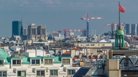 Foto de Vista aérea del paisaje urbano de los hermosos edificios con el timelapse de la catedral de Notre Dame de París desde la terraza de la galería Lafayette en París. Clima soleado en el día de verano. Panorama de azotea - Imagen libre de derechos