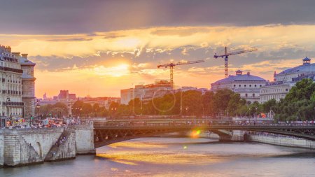 Photo for Le Pont D'Arcole bridge at sunset with boats on Siene river timelapse, Paris, France, Europe. Colorful sky at summer day with reflection on river Seine - Royalty Free Image