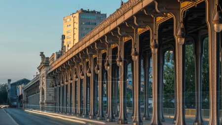 Photo for Seine bridge Bir-Hakeim during sunrise timelapse in the center of Paris a beautiful summer morning light, Paris, France. Traffic on the road and moving shadows - Royalty Free Image