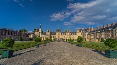 Photo for Royal hunting castle Fontainbleau timelapse hyperlapse front view with entrance. Moving toward. Palace of Fontainebleau - one of largest royal chateaux in France, UNESCO World Heritage Site. - Royalty Free Image