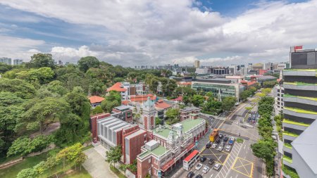Photo for Street traffic near the fire station and skyline of Singapore aerial timelapse. The Central Fire Station is the oldest existing fire station in Singapore on Hill street - Royalty Free Image