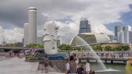 Photo for Merlion fountain and Singapore skyline. Skyscrapers and esplanade theatre on a background. Imaginary creature with a head of a lion and the body of a fish and is often seen as a symbol of Singapore. - Royalty Free Image