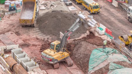 Foto de Un gran sitio de construcción en el timelapse de la ciudad, el proceso de construcción masiva buliding con vehículo pesado en el trabajo, excavadora y excavadora, Singapur - Imagen libre de derechos