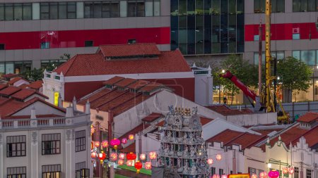 Old houses in Chinatown with Details of the decorations on the roof of the Sri Mariamman Hindu temple aerial day to night transition timelapse, Singapore. Light on the street with traffic Stickers 707662340