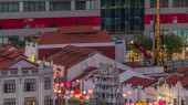 Old houses in Chinatown with Details of the decorations on the roof of the Sri Mariamman Hindu temple aerial day to night transition timelapse, Singapore. Light on the street with traffic Stickers #707662340