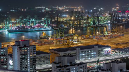 Photo for Commercial port of Singapore night timelapse. Panoramic view of busiest Asian cargo port with hundreds of ships loading export and import goods and thousands of containers in harbor - Royalty Free Image