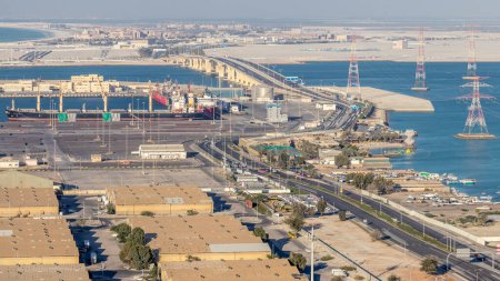 Photo for New Sheikh Khalifa Bridge in Abu Dhabi timelapse aerial view from above, United Arab Emirates. Traffic on the highway road and ship in port - Royalty Free Image