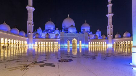 Photo for Sheikh Zayed Grand Mosque illuminated at night timelapse hyperlapse, Abu Dhabi, UAE. Inner court yard. The 3rd largest mosque in the world - Royalty Free Image