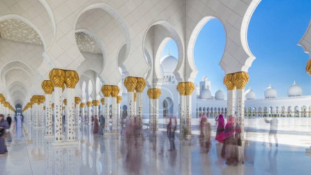 Sheikh Zayed Grand Mosque timelapse in Abu Dhabi, the capital city of United Arab Emirates. People walking between columns. Blue sky at sunny day mug #707666782