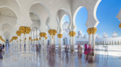 Sheikh Zayed Grand Mosque timelapse in Abu Dhabi, the capital city of United Arab Emirates. People walking between columns. Blue sky at sunny day mug #707666782