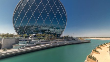 Photo for Circular skyscraper Aldar Headquarters Building timelapse in Abu Dhabi, UAE. View from bridge. It is the first circular building of its kind in the Middle East. - Royalty Free Image