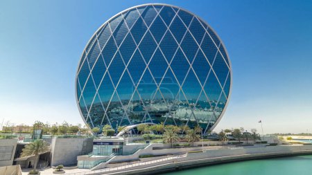 Téléchargez les photos : Gratte-ciel circulaire Aldar Siège Immeuble timelapse hyperlapse à Abu Dhabi, Émirats arabes unis. Vue depuis le pont. C'est le premier bâtiment circulaire du genre au Moyen-Orient.. - en image libre de droit