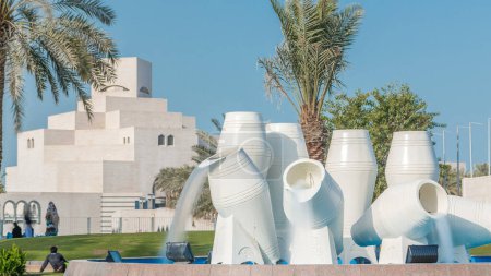 Foto de Corniche en Doha con las ollas de agua fuente timelapse hito, con el horizonte de las torres de negocios distantes. Museo Islámico está en el fondo. - Imagen libre de derechos