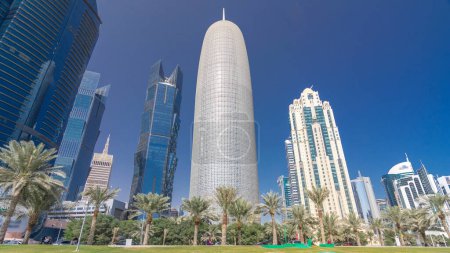 The skyline of Doha seen from Park timelapse hyperlapse, Qatar. Trees and palms on foreground. Modern skyscrapers and towers on background. Traffic on road magic mug #707668748