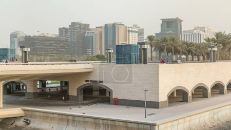 Photo for View of the Doha city in front of the Museum park evening timelapse in the Qatari capital, Doha. Boats and bridge - Royalty Free Image